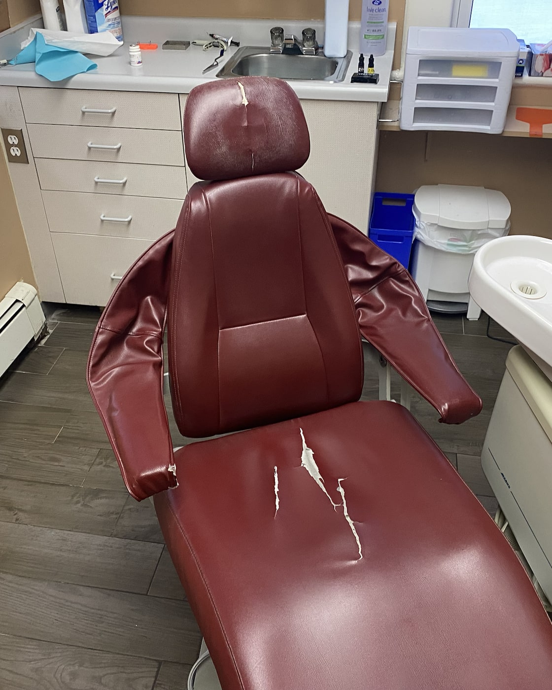 Dental chair with damaged upholstery before restoration